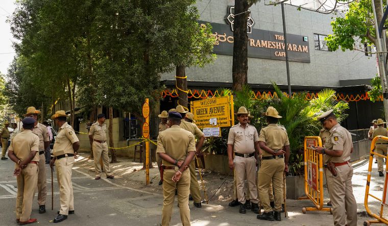 Security personnel stand guard at the Rameshwaram cafe blast site, in Bengaluru